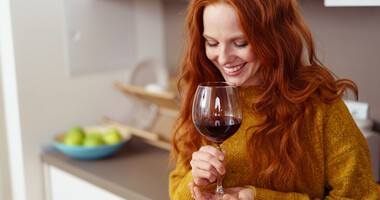 Kobieta pije wino z kieliszka