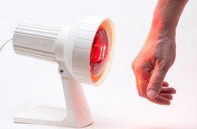 Dłoń mężczyzny naświetlana promieniowaniem podczerwonym (IR) z lampy sollux
