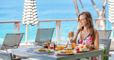 dieta na urlopie, jak nie przytyć w wakacje, kobieta je lunch na urlopie