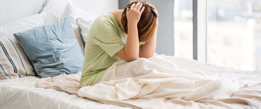 Kobieta cierpiąca na ból z tyłu głowy, ból głowy z tyłu, ból głowy i karku, ból potylicy.