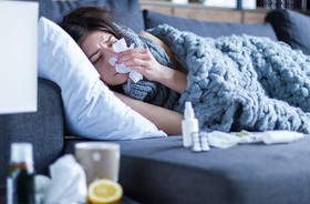 chora na grypę kobieta leży w lóżku