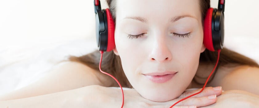 Kobieta w słuchawkach w czasie muzykoterapii
